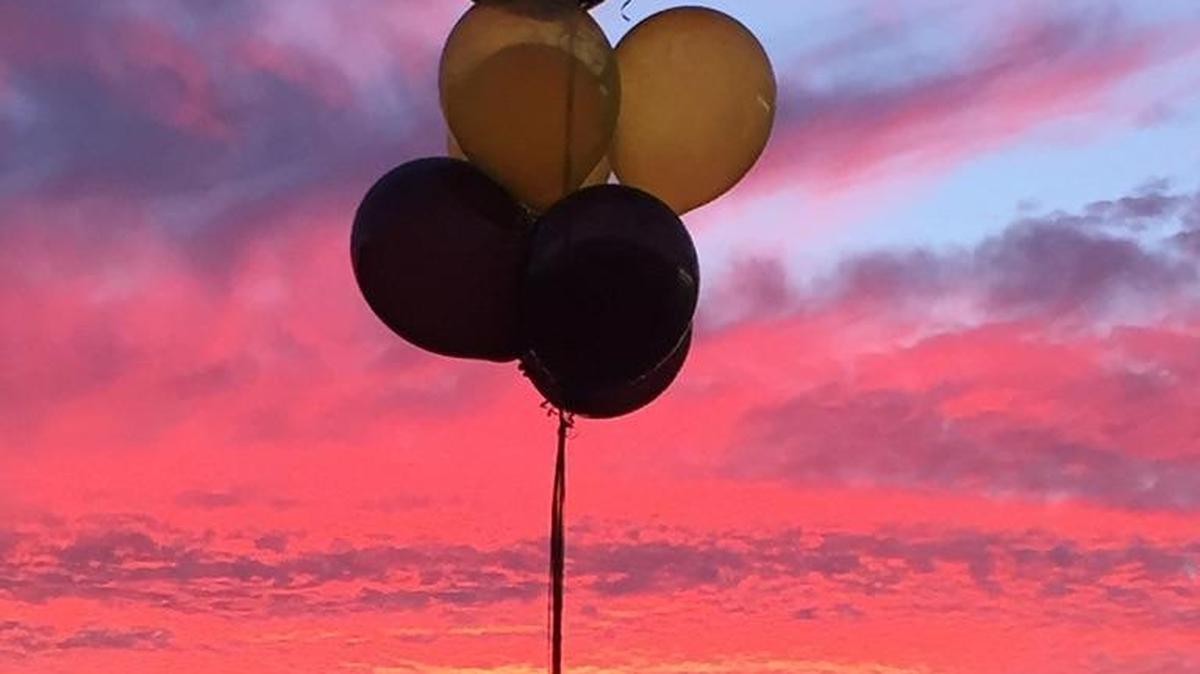 Balloons stand against the sunset Dec. 2 at a candlelight vigil at Denair Elementary Charter Academy in Denair, Calif., to honor fourth grade teacher Mark Selee who died Nov. 22.