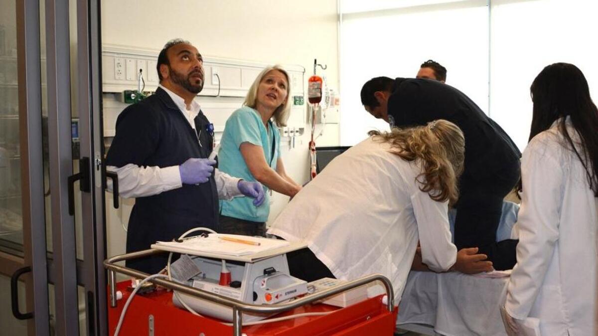 Nursing students race to save a pretend patient during a collaborative Code Blue drill at Modesto Junior College in Modesto, CA, in March 2015.