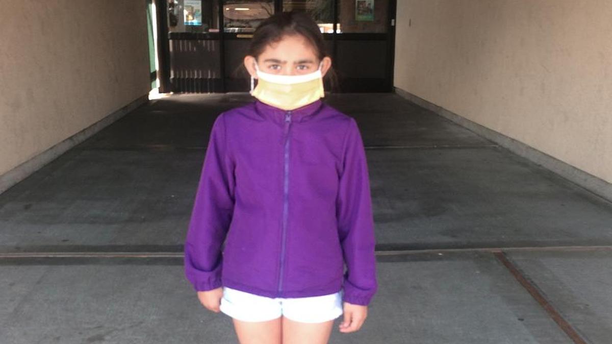 Third-grader Erika Nataliah Tellez, 9, leaves Sonoma Elementary in Modesto, Calif., after spending an hour there finishing state testing despite a 102 degree fever, pneumonia and a confirmed case of influenza A on March 15, 2017.