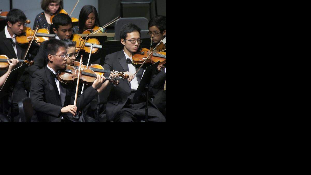 
The Gregori High School Orchestra, including first chair violinist David Oh and under the direction of Dan Bryan, performs on stage at the MJC High School Orchestra Day held at the Performing and Media Arts Center Auditorium, Nov. 6, 2014.
