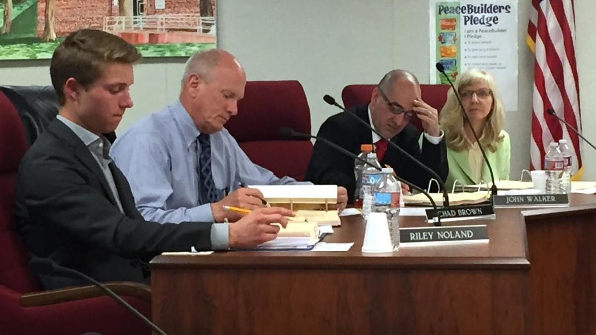 Chad Brown, second from left, takes his seat on the Modesto City Schools board alongside student trustee Riley Noland and trustees John Walker and Cindy Marks in Modesto, Calif., on Monday, March 21, 2016.