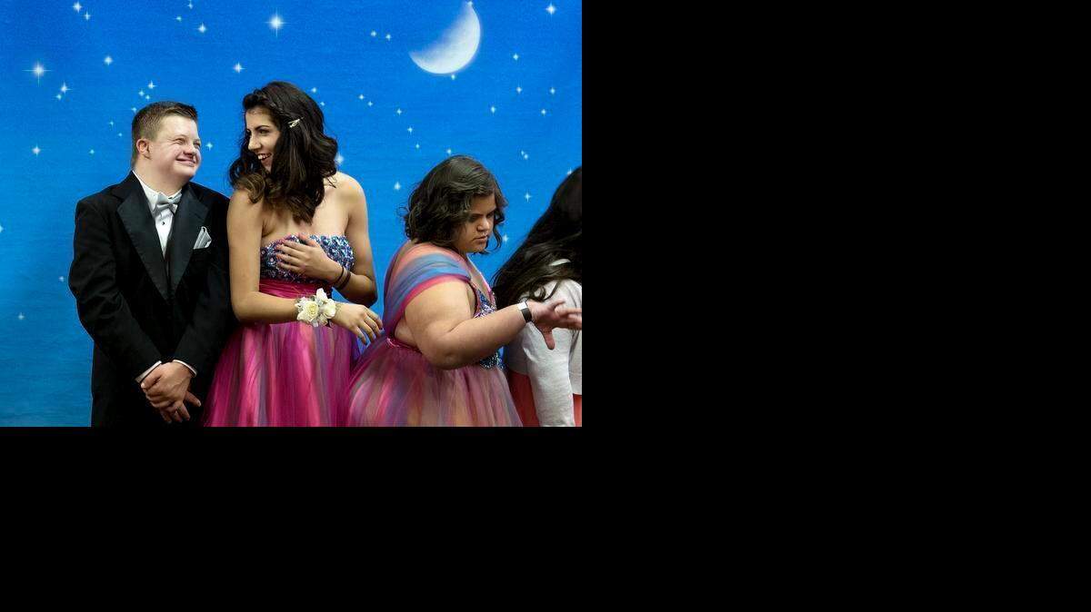 
Porter Scoffield, 15, smiles at his date, Katarina Argandar, 17, as they have their picture taken during the Beyer High School Winter Formal at The Seasons in Modesto on Saturday. Katarina brought several friends from the Beyer special education class where she is a volunteer.
