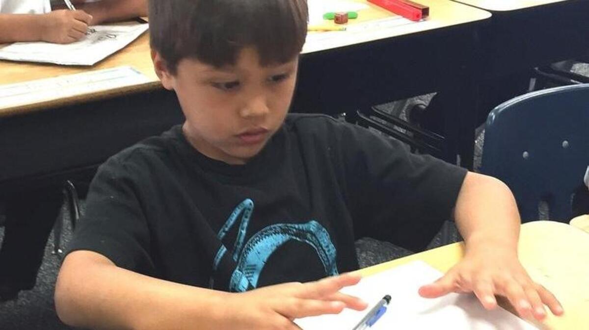 First-grader Johnathan Herrera uses his fingers to count up a multiplication problem at Las Palmas Elementary in Patterson on March 1, 2016. Fingers are an acknowledged tool in Common Core math.