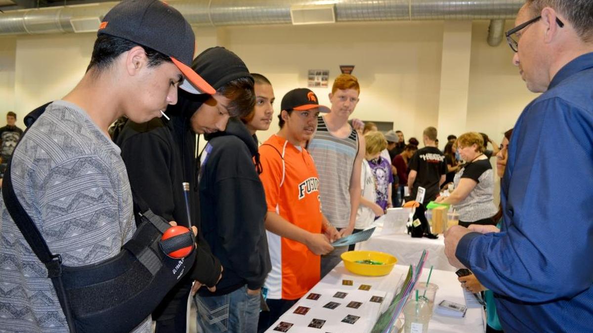 Fusion Charter student Kyle Scott speaks to Dustin Pack of Project YES, a grant-funded job training and placement service, at a career fair Tuesday, April 5, 2016, at the campus in Turlock.