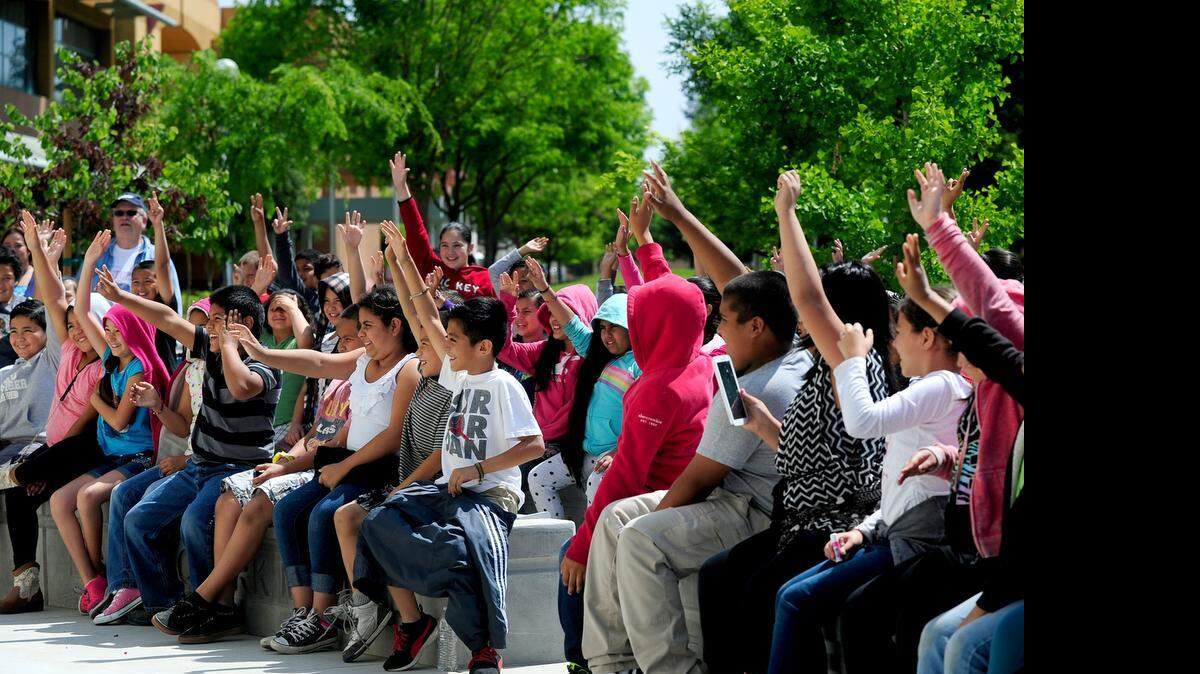 
Students from Marshall Elementary School raise their hands while participating in a chemistry demonstration in front of the Great Valley Museum at the Modesto Junior College West Campus in Modesto on Thursday.
