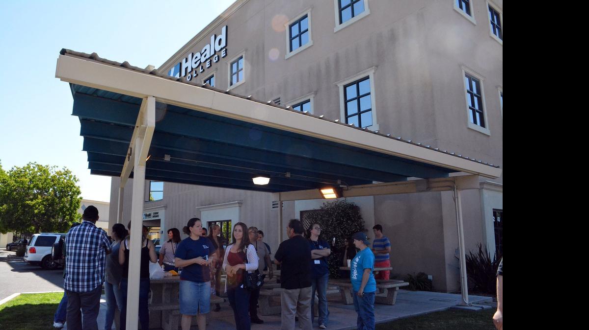 
Students and instructors gather outside the shuttered Heald College campus north of Modesto on April 27, the day after getting emails and texts saying the school would close one week into the quarter. Recent graduates are now organizing their own graduation ceremony.

