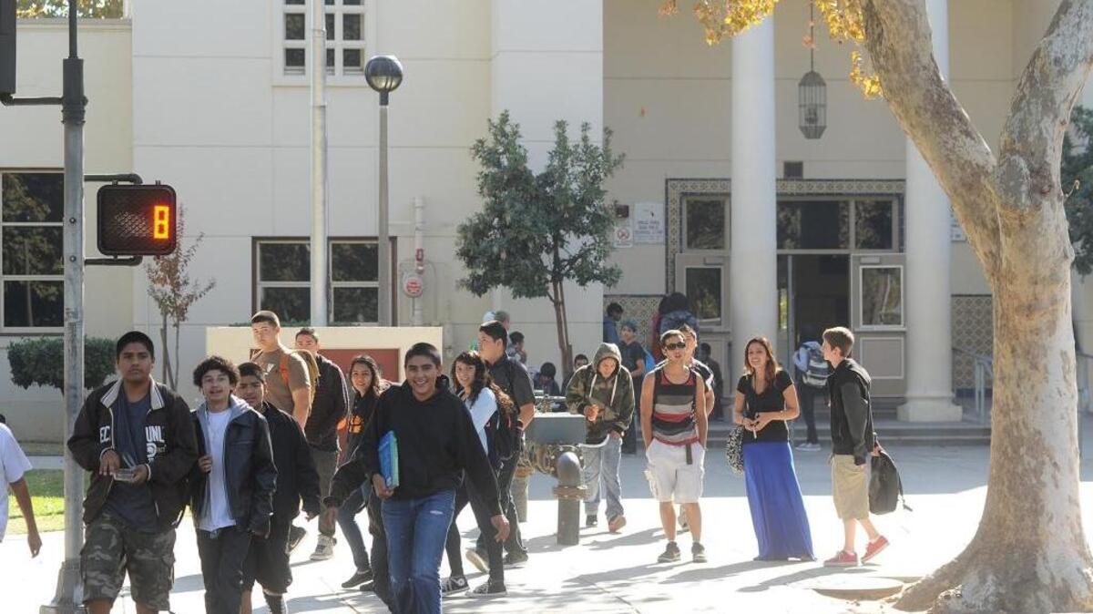 Some of Modesto High School’s roughly 2,400 students cross the street dividing the Modesto High campus between classes in 2013. Behind them is the single door hundreds of students must crowd through every passing period. The campus needs $56 million in repairs and upgrades, according to a facilities report up for discussion by the Modesto City Schools board.