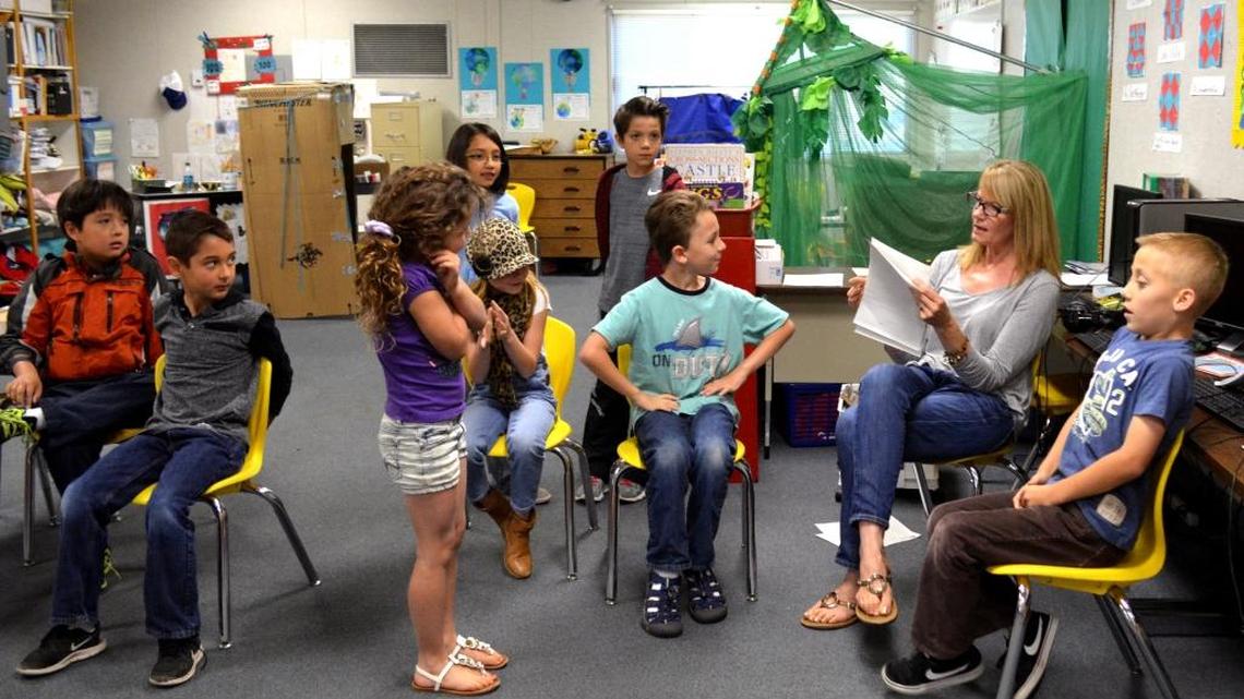 Teacher Lisa Fogarty works with first-graders on an evaluation of written paragraphs while an aide works with second-graders of the combined class in another room on Thursday, April 28, 2016, at Knights Ferry School, named a 2016 Gold Ribbon School, in Knights Ferry.