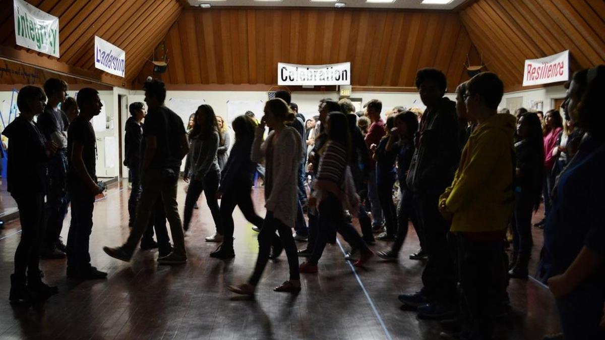 Students cross the line during an exercise at the Valley Charter High School assembly.