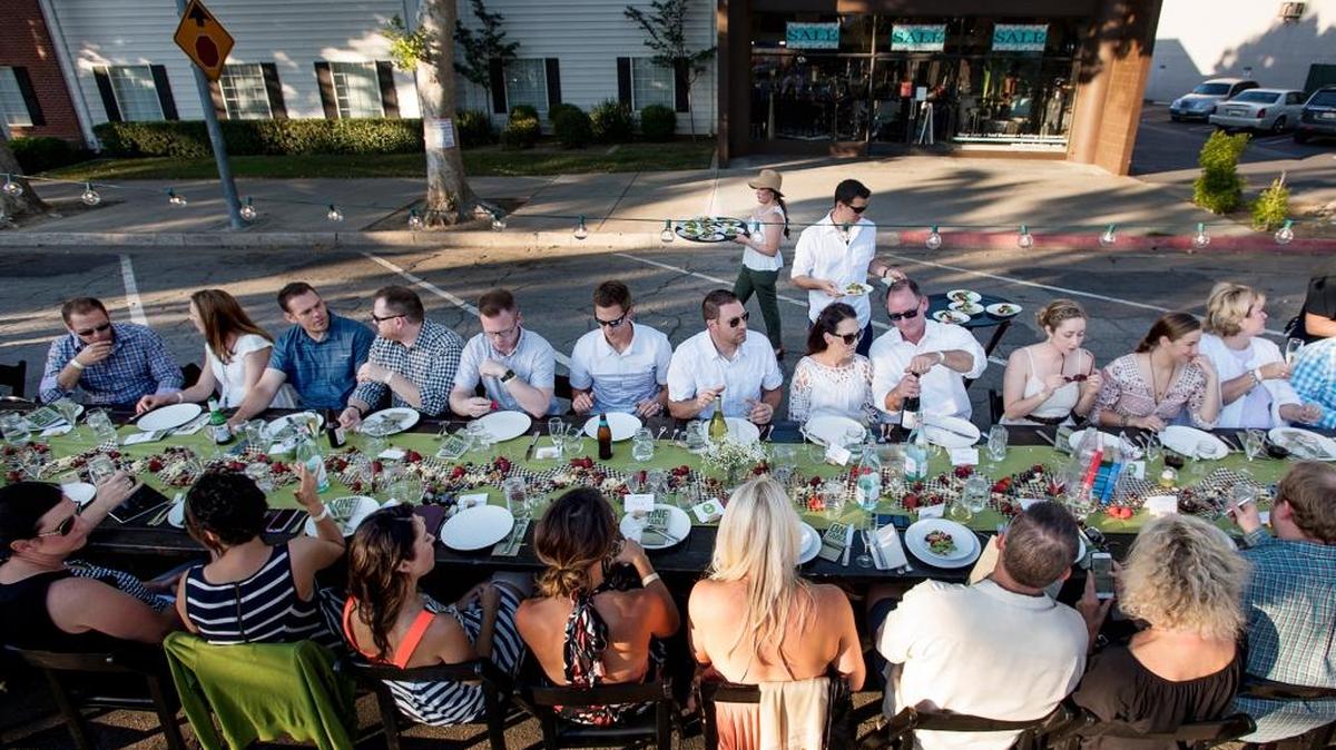 About 300 people dine during the One Table community dinner fundraiser for the United Way of Stanislaus County in Modesto, Calif., on Sunday, May 15, 2016. The money supports Graduation Coach, which provides mentors for at-risk students and their parents at seven schools.