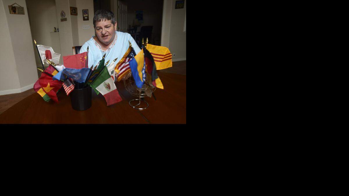
Carol Berger of the American Cultural Exchange Service has worked with international exchange programs for 26 years either as a host or an exchange service representative. Berger is pictured with her collection of international flags at her Riverbank home on Friday.
