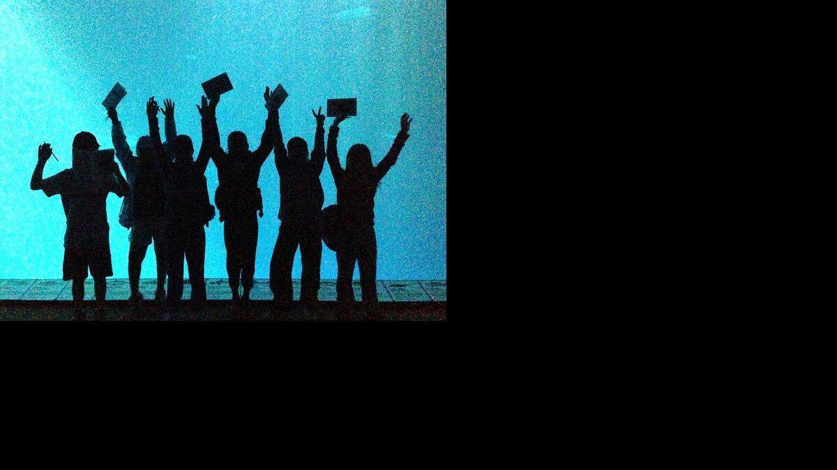 
Turlock fifth-graders stand in front of the giant tank of the Monterey Bay Aquarium during a field trip to Monterey and Del Monte State Beach on Oct. 7, 2014.
