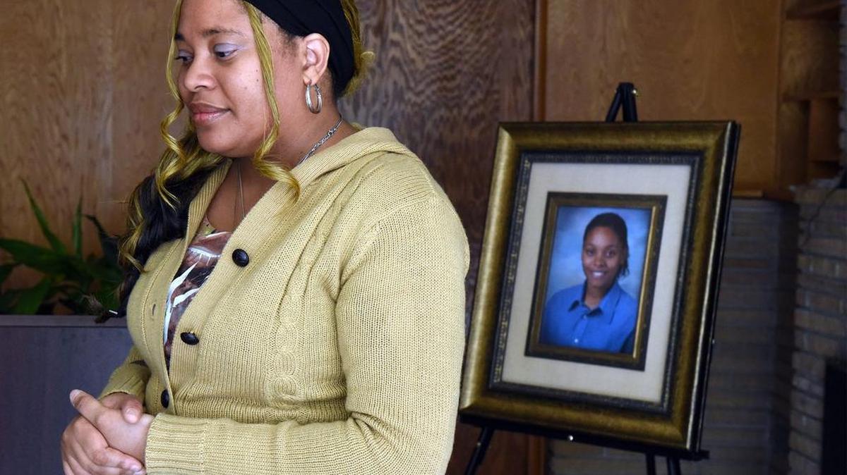 Latisha Cyprian, in March 2017, with a portrait of her daughter, Doneisha Neil, who committed suicide in 2015.