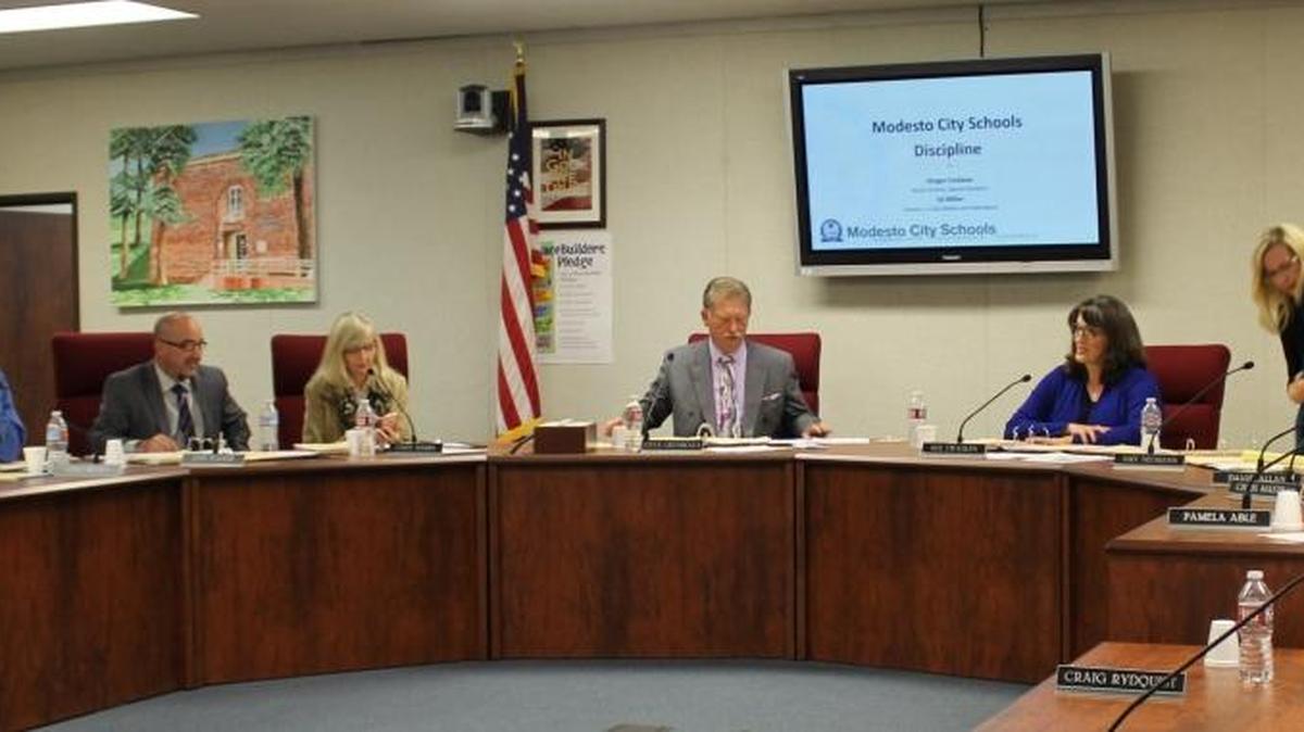 Modesto City Schools Board outgoing President Steve Grenbeaux calls a meeting to order. Grenbeaux handed the gavel to Sue Zwahlen, beside him at right, Dec. 5, 2016, in Modesto.