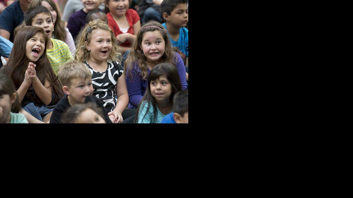
First-grade students – from left, Giana Melendez, 7, Era Kuehl, 6, and Dakota Royer, 7 – react as violinist Aaron Meyer plays rock music on the violin during the Modesto Community Concert Association’s music outreach program at Mary Ann Sanders Elementary in north Modesto on Monday.
