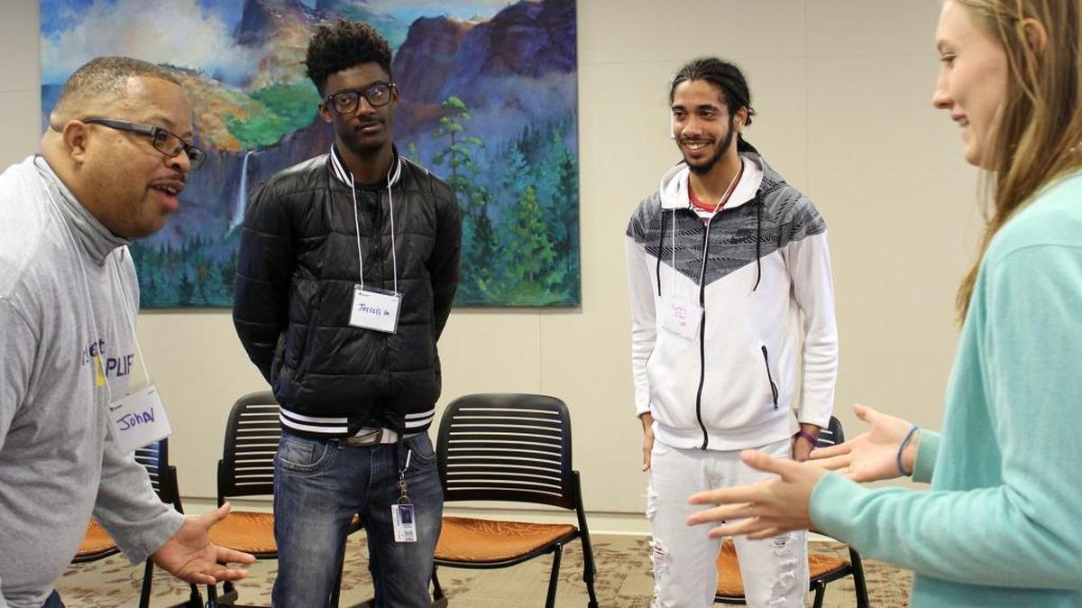Project Uplift founder John Ervin III does an ice breaker with students, from left, Jerrell Griffin and Curtis Fifer III, both 16 and from Modesto, and UC Merced student Katie Adams Arca during a meeting at UC Merced on Dec. 3.