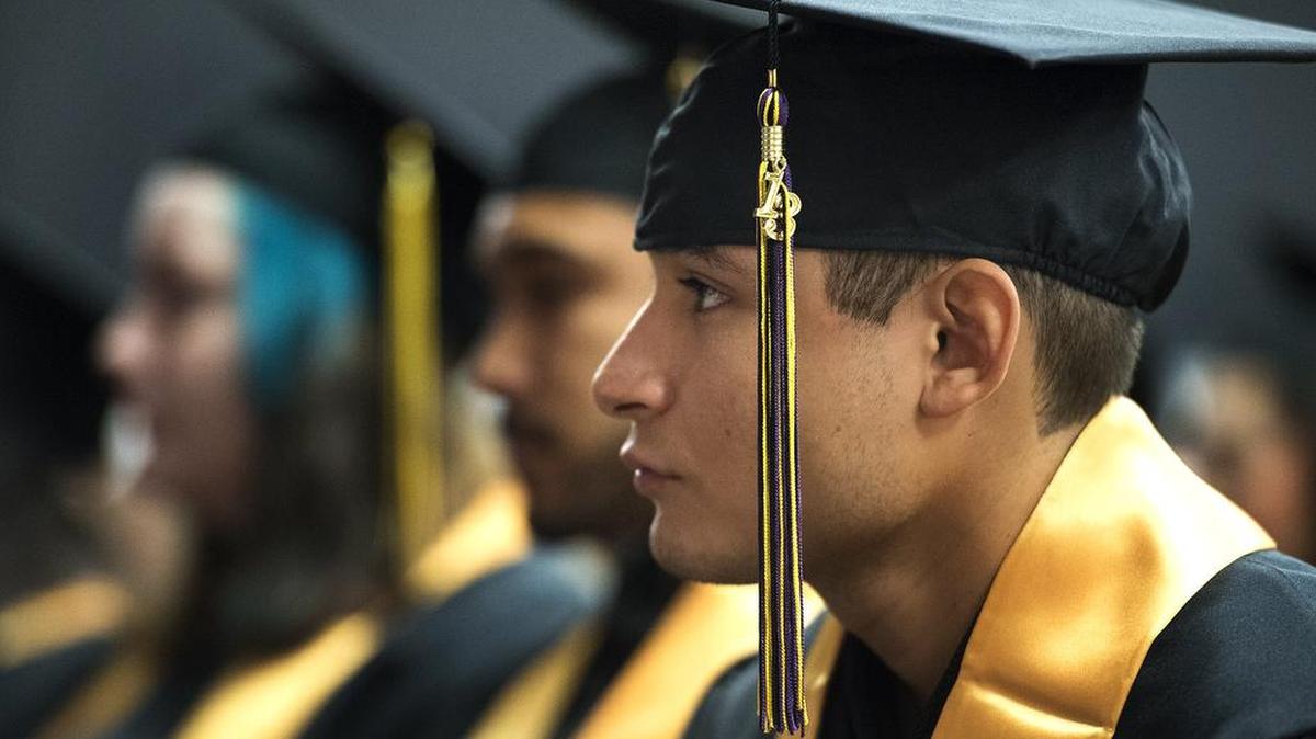 Giovanni Rubio listens to a student speaker during a commencement ceremony for the first graduating class from the Come Back Kids program in December 2013. The Come Back Kids program, run by the Stanislaus County Office of Education, gives dropouts a second chance to finish their work and receive a high school diploma.