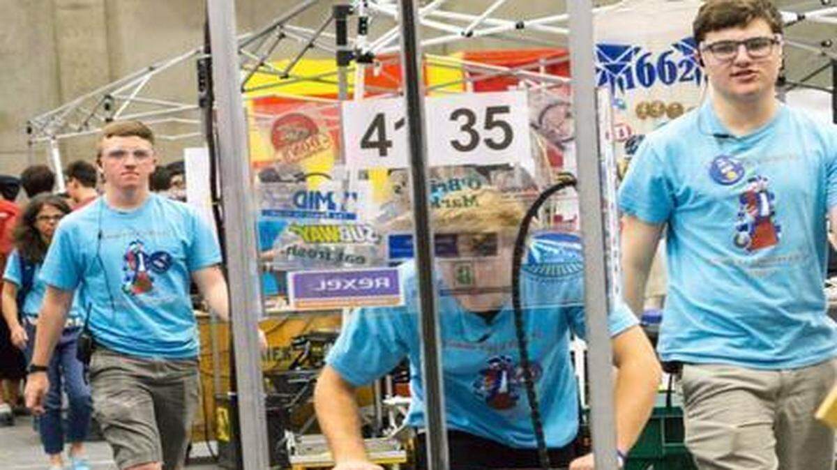 
Beyer High robotics team members Matthew Laverty, Mason Fernandez and Joe Dion move their robot for inspection during the FIRST Robotics Competition in Madera over the weekend.
