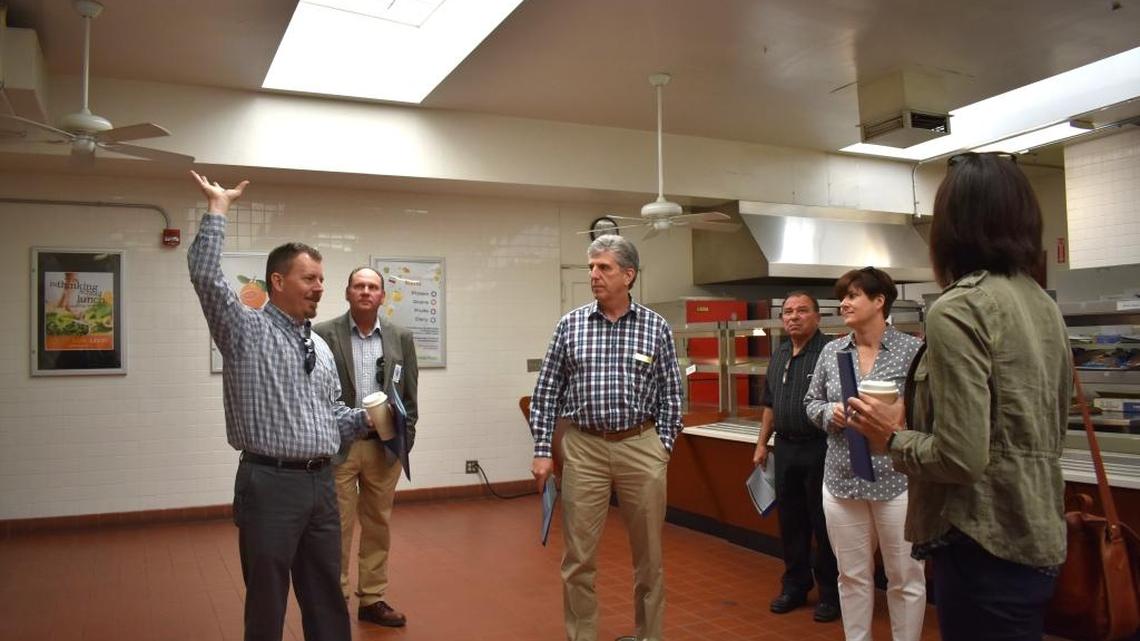 Scott Richardson, head of Turlock Unified maintenance operations, points to original air conditioning housed within the attic of the 1951 Turlock High cafeteria, only replaceable by removing the roof, during a tour of the sprawling campus by school board members, including Frank Lima, center, on April 5, 2017, in Turlock, CA.