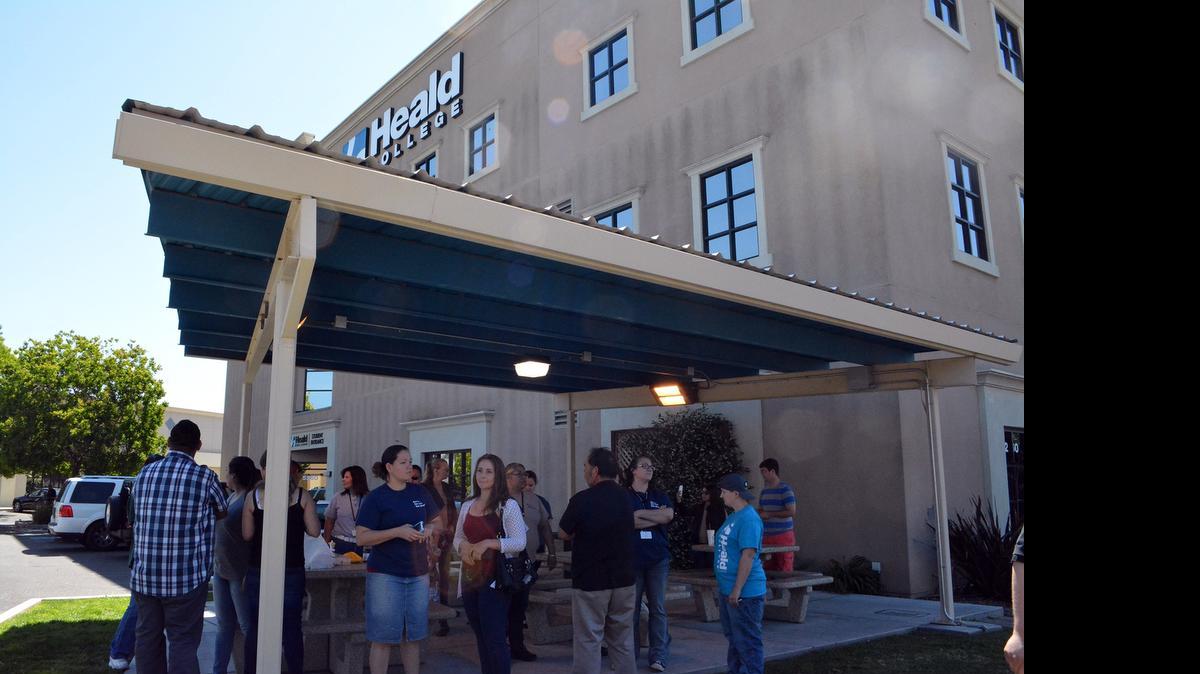 
Students and instructors gather outside the Heald College campus north of Modesto on Monday. Students got emails or text messages early Sunday saying the school would close.
