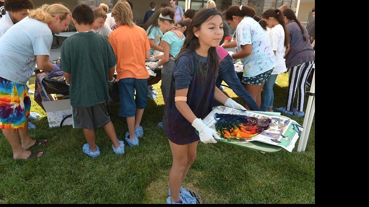 
Naomi Machado, 12, of Waterford takes her finished tie-dye project to dry Thursday during the Road Trip summer camp at the Stanislaus County Institute of Learning in Ceres. Harmony Tie-Dyes of Modesto was on hand for a tie-dye project.
