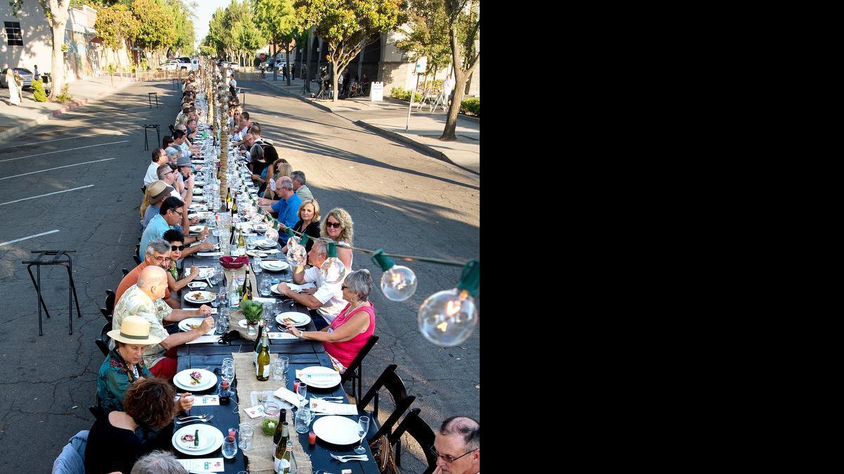 
The One Table dinner party benefits the United Way of Stanislaus County’s Graduation Coach program. Two hundred people ate together on a 150-foot-long table on 15th Street in Modesto on Sunday.
