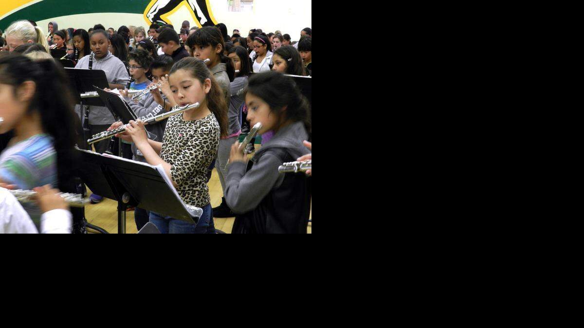 
Flutist Brooklynn Banuelos, a John Muir School fifth-grader, rehearses the song “Bingo” with fellow musicians in the Davis High School gym on Tuesday  for the district’s annual music festival concerts being performed Tuesday and Wednesday evenings.
