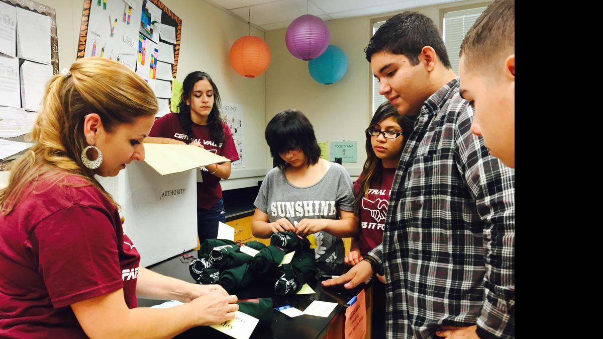
Students and teacher Natalie Rowell, left, tie upbeat messages to shirts for graduating seniors as part of Pay it Forward week activities in the Success 101 class at Central Valley High School in Ceres on Monday.
