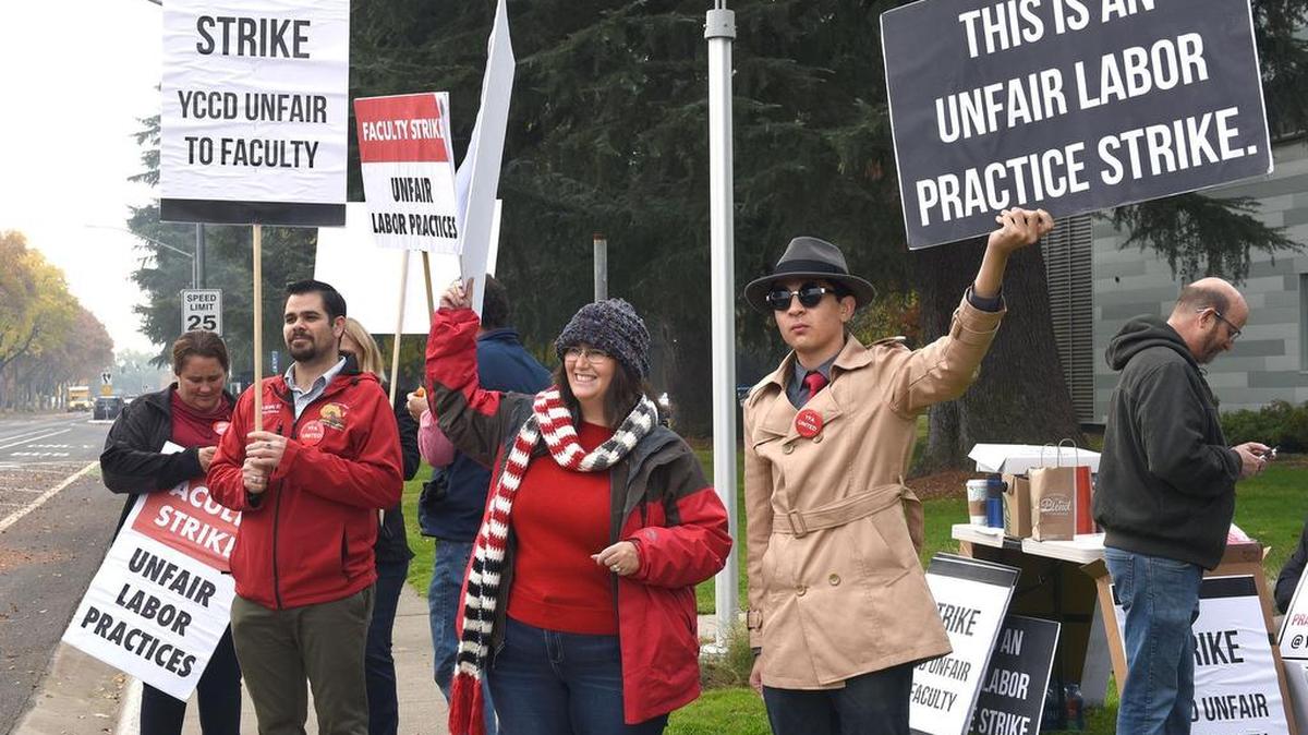 Aristotle Tagbo (center right) and Tina Giron (center) participate in a strike on Tuesday morning November 27, 2018 at the Modesto Junior College East campus.