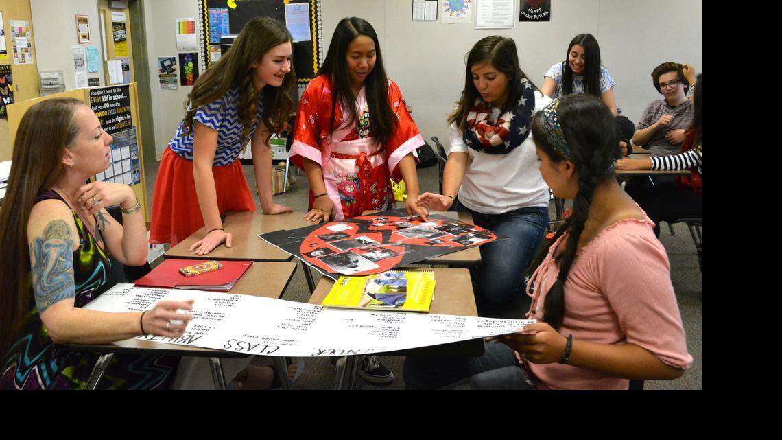 
Healthy and Responsible Relationship Troupe members talk about their group poster with Haven Women’s Center’s Holly Grace Palmer, left, during a meeting Wednesday  at Enochs High School in Modesto. The HARRT project at Enochs and Riverbank High are a pilot project for the state using teens to spread the message about healthy relationships.

