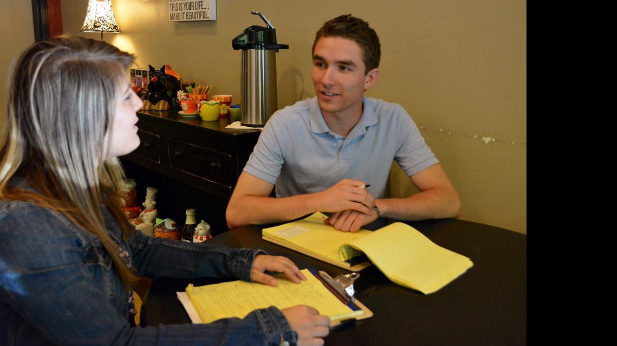
California State University, Stanislaus, student interns Sydney Riley, left, and James Governale discuss plans Wednesday to add content to the downtown Turlock website .
