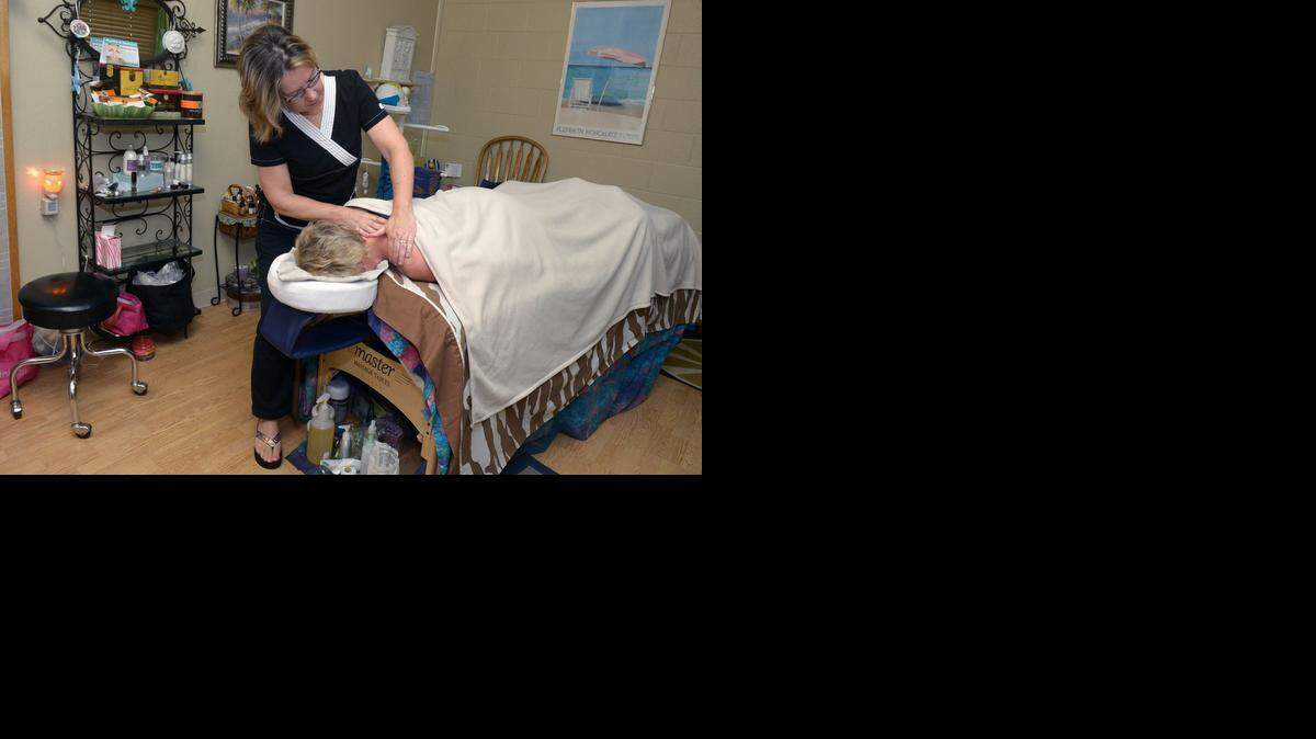 
Cynthia Flesher, a certified massage therapist, works on a client Friday morning in Turlock.

