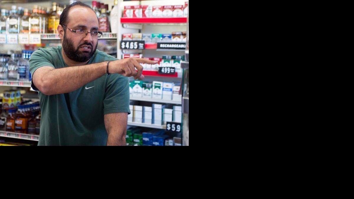
Jessie Singh, owner of House of Liquor, points outside to the construction work on the new Kiernan overpass in Salida on Sunday.
