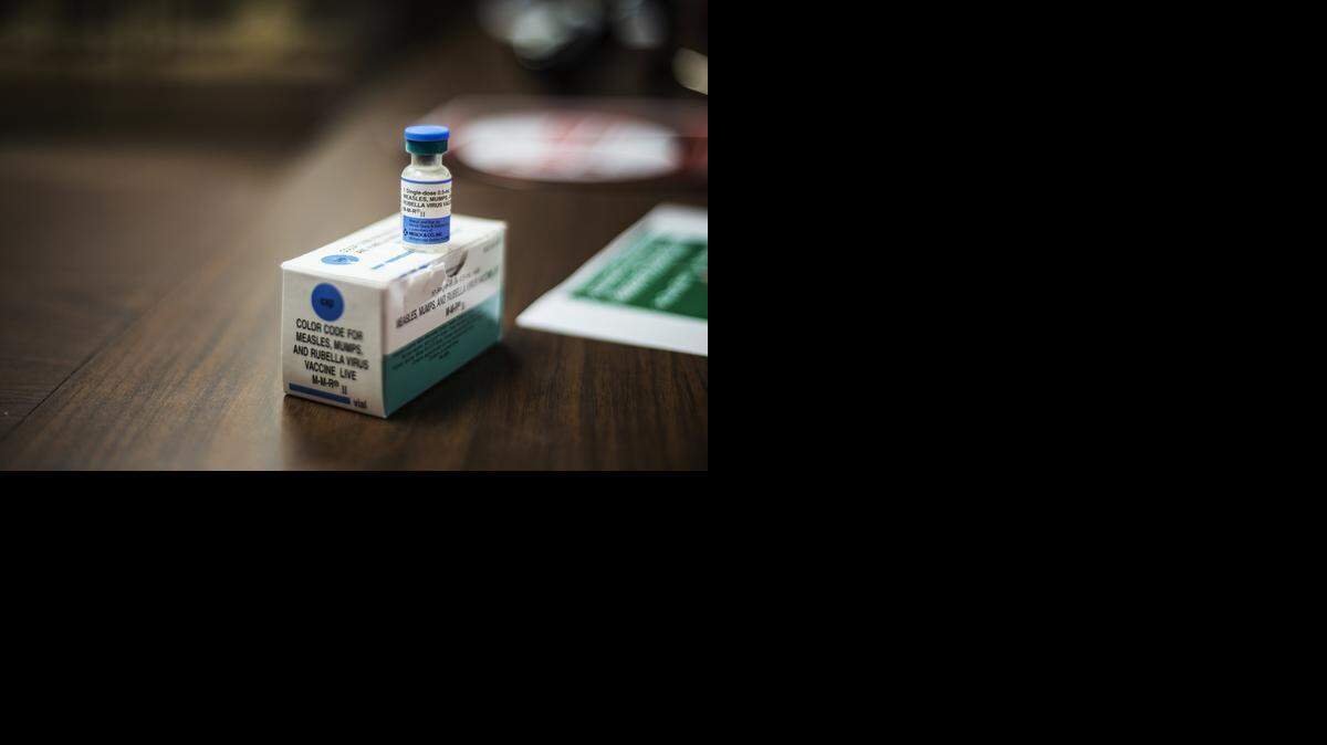 A vial containing the measles, mumps, and rubella vaccine was on display at Tuesday’s news conference. The source of the child’s exposure has not been determined.