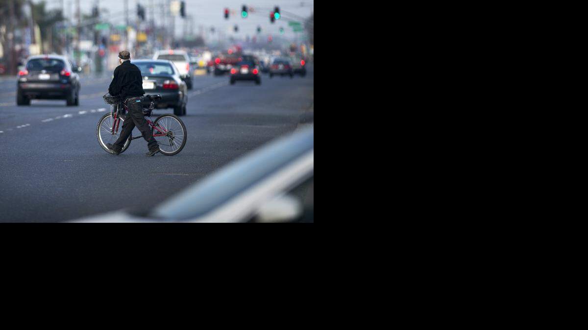 
A bicyclist crosses through busy traffic on Crows Landing Road in Modesto on Friday.
