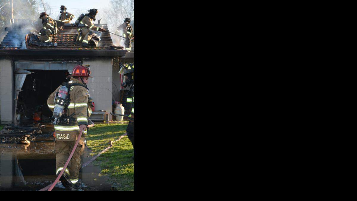 
Modesto firefighters work to put out a fire at a home on Dora Street in southeast Modesto on Wednesday. The Modesto Fire Department said the fire was contained to the garage and caused about $40,000 in damage.
