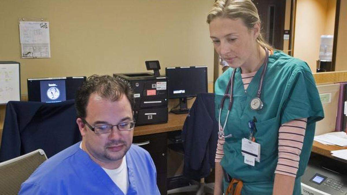 In this April 2015 photo, Nicole McLawrence, then in her second year of residency in family medicine, looks at a monitor with critical care technician Kenneth Perkins  at Doctors Medical Center in Modesto. The Affordable Care Act created Teaching Health Center grants that paid for additional slots for the Valley Family Medicine Residency at DMC, but the funding ends this year.