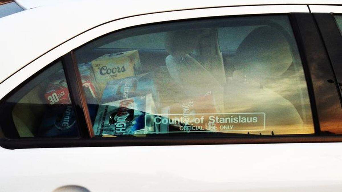 
A county vehicle with a back seat stacked with beer cases was photographed outside a grocery store in Ceres on Wednesday.
