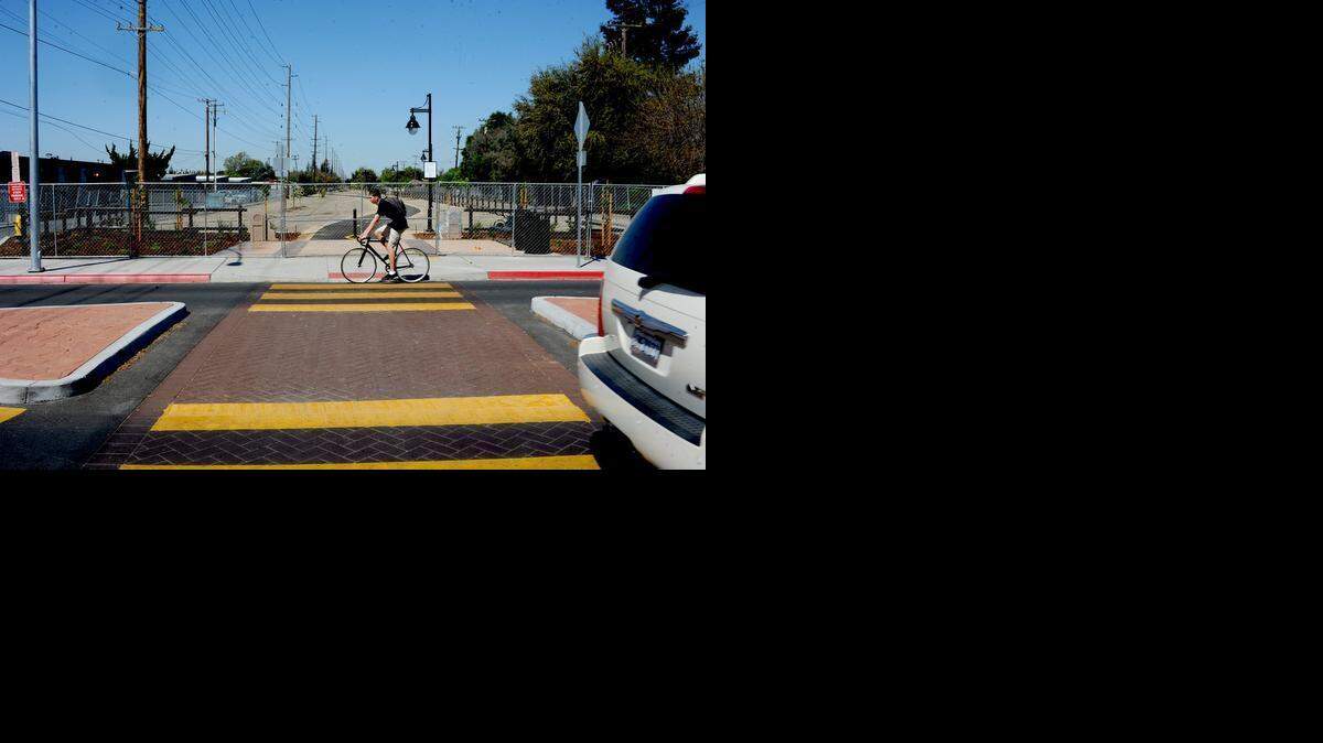 
A cyclist rides past a section of trail that officials say will not be open for another two months, on Friday  along Bowen Avenue at the Virginia Corridor in Modesto.
