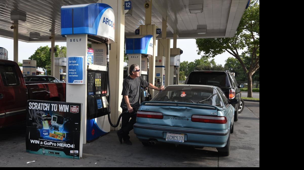 
Douglas Filwau of Modesto pumps gas at an Arco station during the morning commute Thursday at Fifth and I streets in Modesto. The station was among those with the cheapest gas prices in the area.
