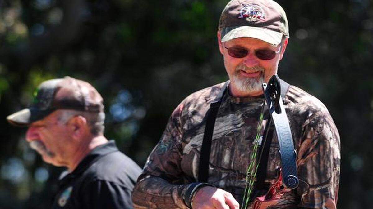 
Club President Wayne Lehr loads his compound bow right after Bob Mattos, left, had taken a shot at a target, during the West Coast Open bow-and-arrow competition at the Orestimba Field Archers Club near Newman on Sunday. The West Coast Traditional Championship takes place next weekend at the club.
