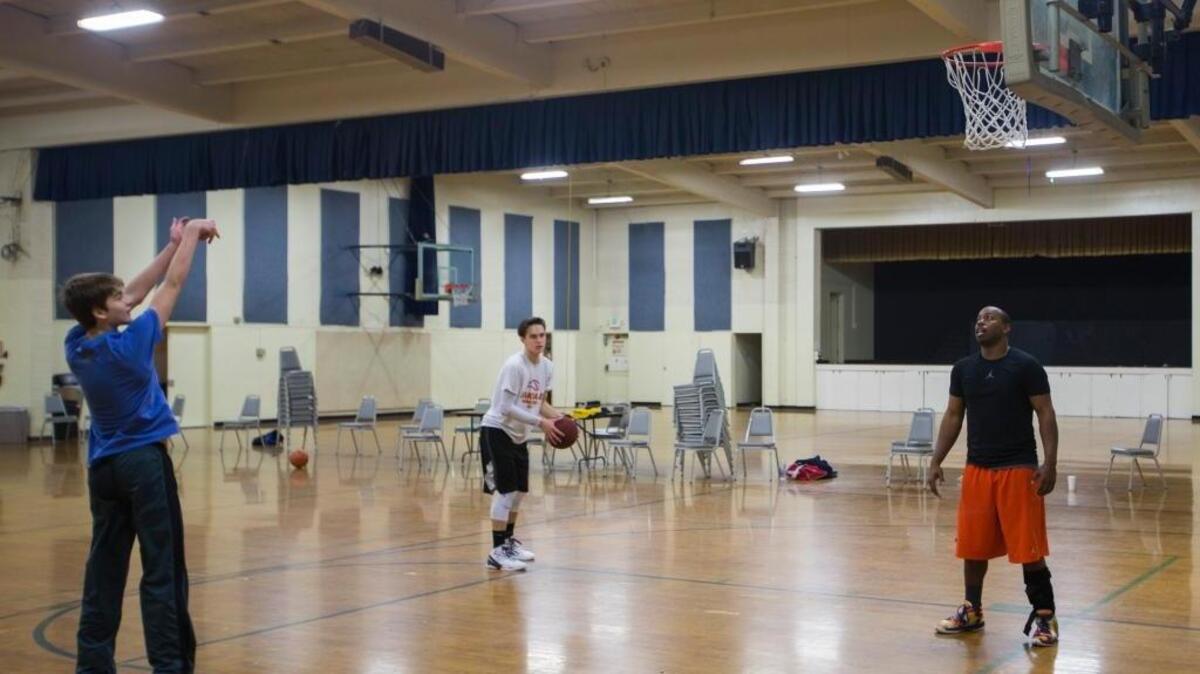 From left, Chris Heiny, Aron Cameron, and Marqueis Eddings practice shooting hoops in the large gym at the Sportsmen of Stanislaus Club. Modesto’s Planning Commission will consider recommending the City Council approve a K-12 charter school, sponsored by tennis champion Andre Agassi, at the site.