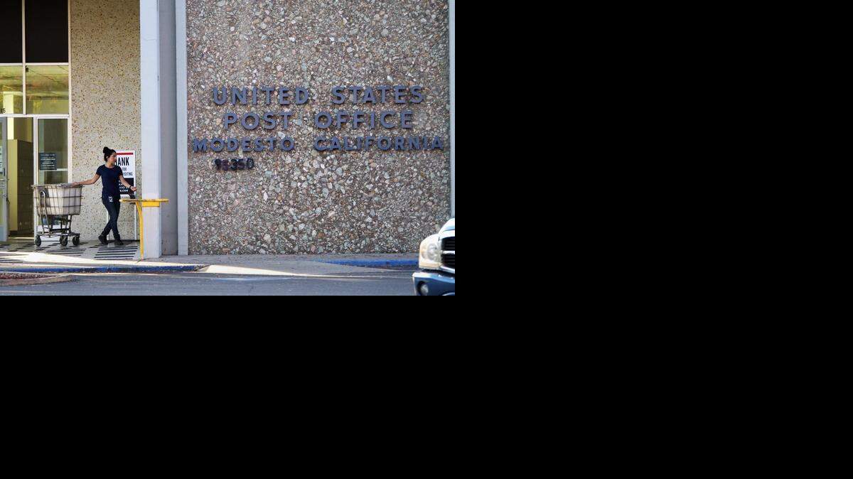 
A postal worker pulls her cart to enter the lobby at the Kearney Avenue post office on Friday. The U.S. Postal Service is hiring, and job seekers can participate in the first USPS online career fair.

