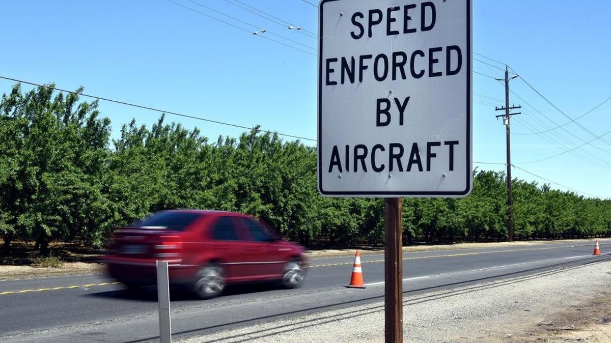 A “Speed enforced by aircraft” sign is pictured Friday afternoon (04-14-17) on Yosemite Blvd. at Leek Road in Empire, Calif.