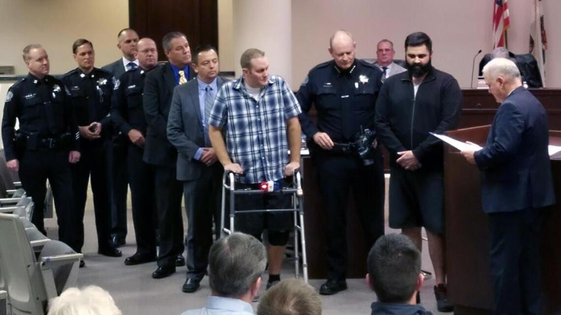 City honors good Samaritan for helping officer hurt in crash