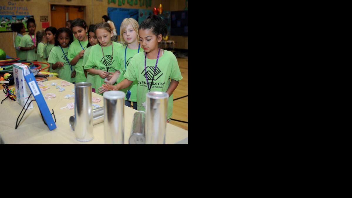 Desiree Soto, 9, right, talks with other children about a science station during the National Boys & Girls Club Week open house at Sylvan Elementary School on Friday in Modesto.
