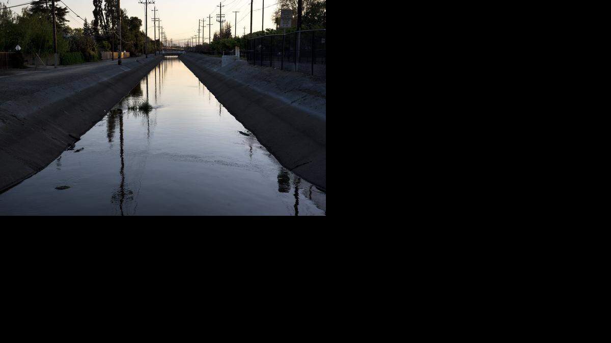 
Water flows through an irrigation canal off Virginia Avenue in Modesto on Thursday.
