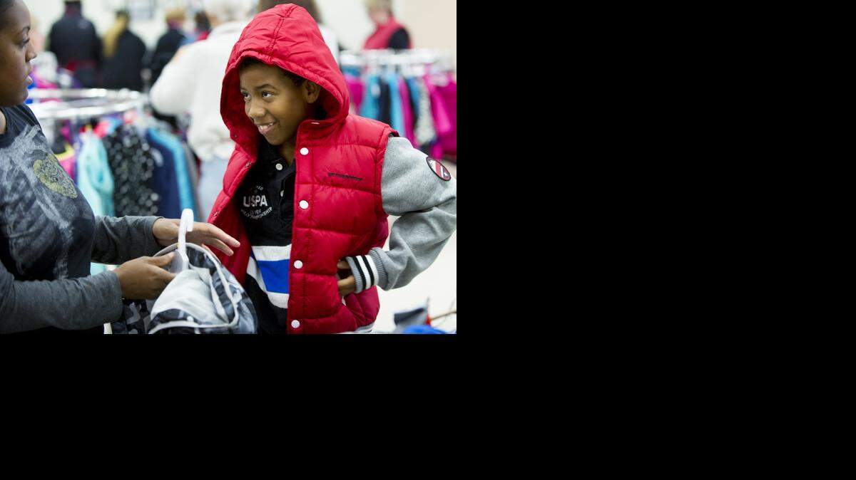 
Clinton Powell, 11, chooses a coat with his mother, Tashawna Powell, during the Coats for Kids event at the Salvation Army in Modesto on Saturday.

