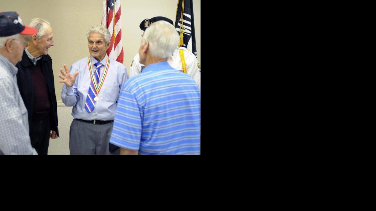 
Gene Benedix talks to his Bible study group, which helped organize the awarding of the Purple Heart Medal to him at the Oakdale senior center on Tuesday. 
