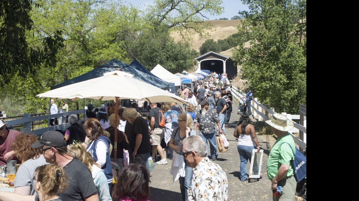 
Patrons and vendors line up near the Covered Bridge during the Knights Ferry Gold Country Peddler’s Faire in Knights Ferry on Sunday.
